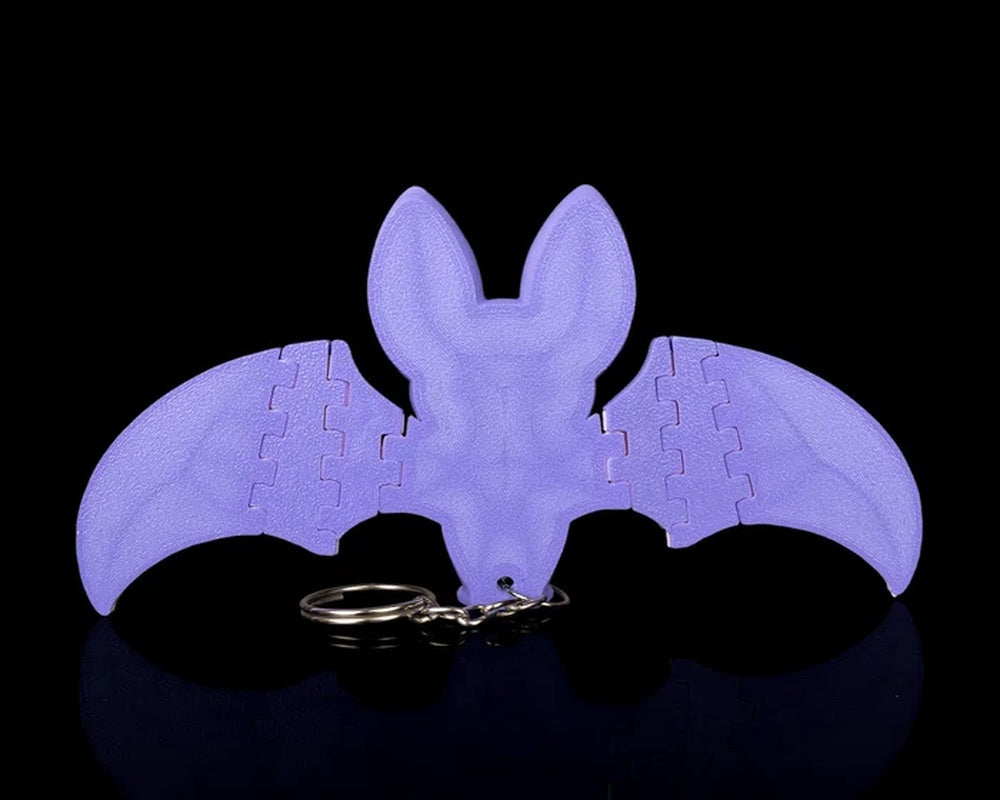 Back view of a purple bat with spread wings and a metal ring below