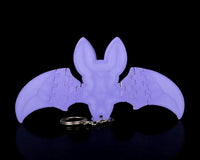 Back view of a purple bat with spread wings and a metal ring below
