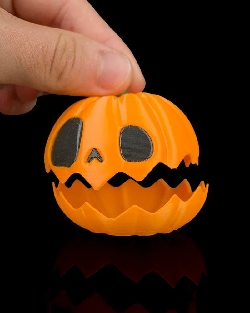 Hand lifting the top of an orange jack-o'-lantern pumpkin with a jagged opening