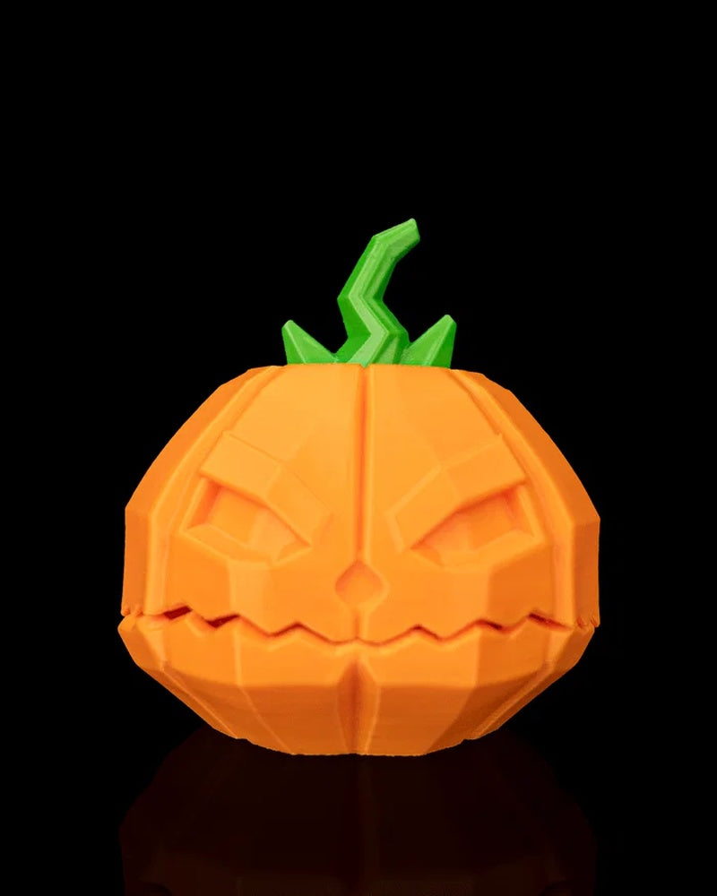 Front view of an orange jack-o'-lantern pumpkin object with a green stem on a black background