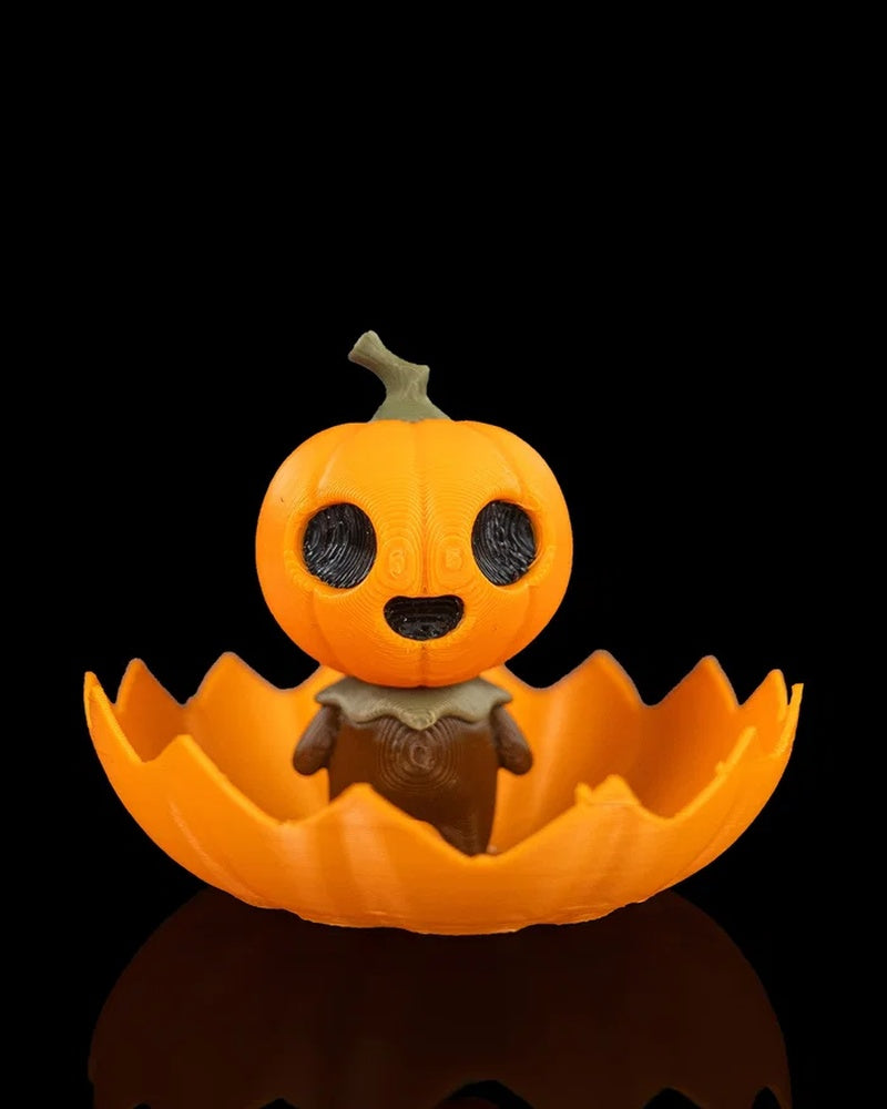 Orange pumpkin character figurine sitting inside a jagged pumpkin shell on a black background