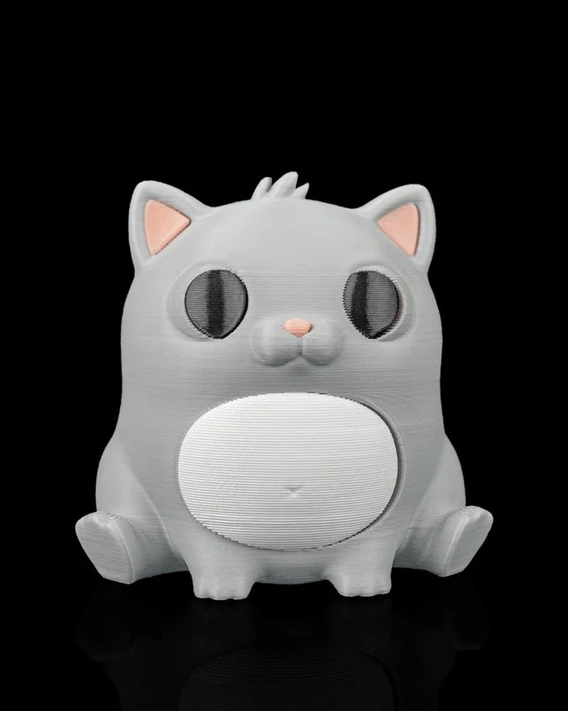 Front view of a gray cat figure with dark eyes, pink ears, a pink nose, and a white belly on a black background.