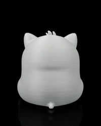 Rear view of a gray cat figure showing pointed ears, a small tail, and a rounded back.
