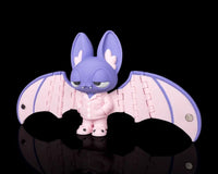 Purple and pink bat figure with wide wings on a black background at an angle