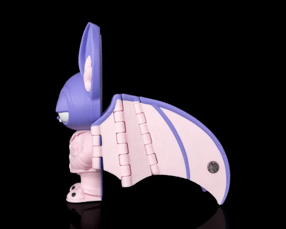 Side view of a purple and pink bat figure with one wing extended