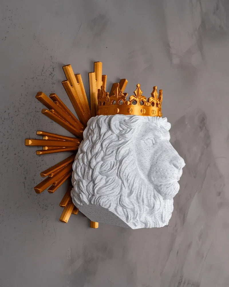 Side view of a white lion head figurine with a gold crown and gold rays on a gray background