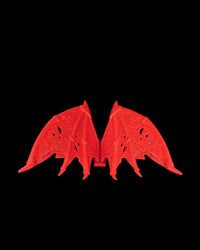 Pair of red wing pieces on a black background.