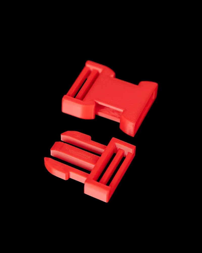 Two red buckle-like pieces on a black background.