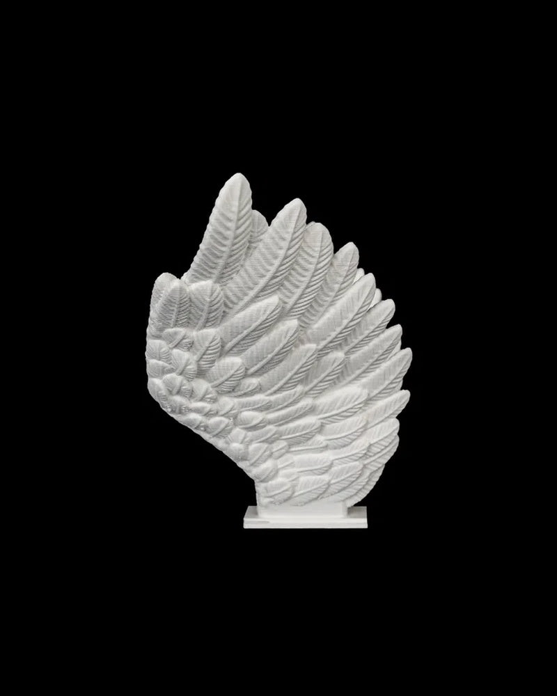 Side view of a white feather-style wing piece on a black background