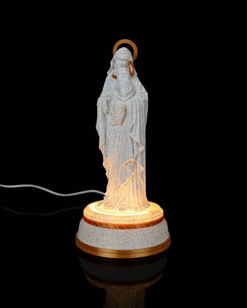 Mary holding Jesus statue shown from an angled front view on a glowing round base against a black background