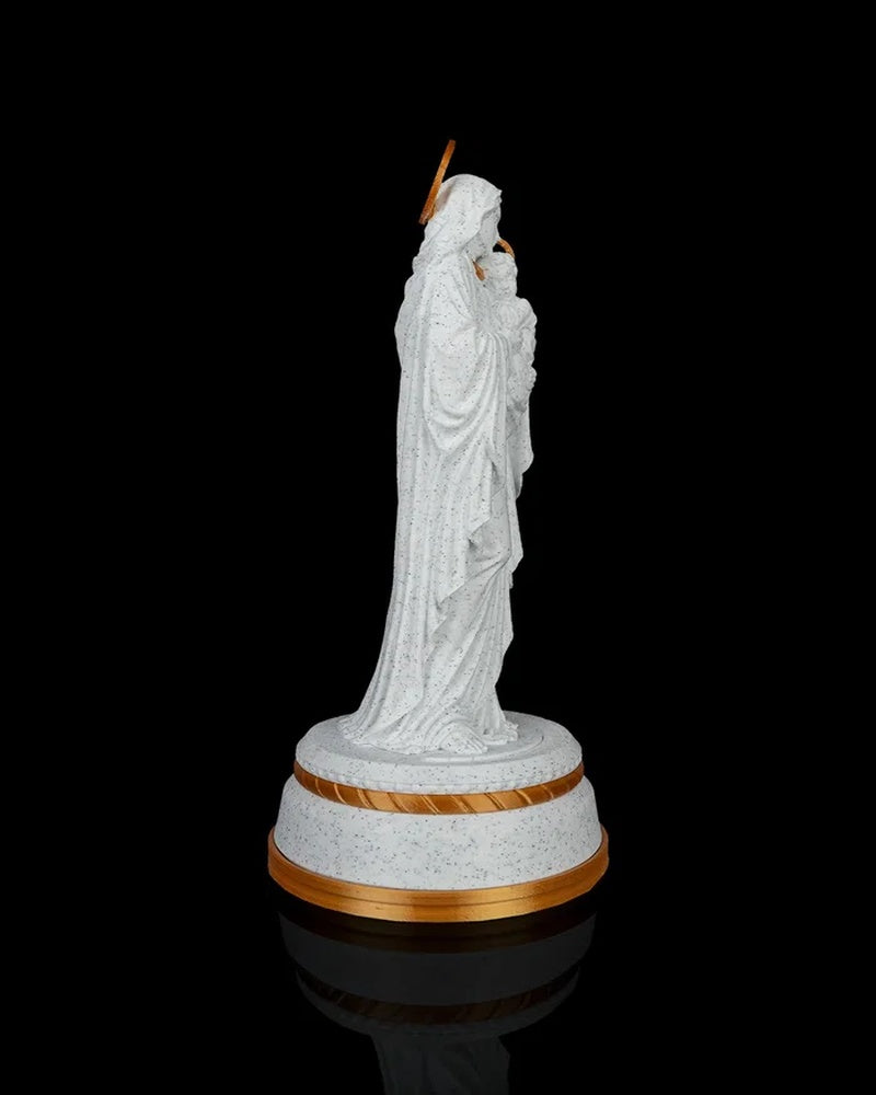 Side view of a Mary holding Jesus statue on a round base against a black background