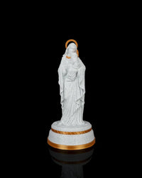 Mary holding Jesus statue on a round base against a black background with gold halo and trim accents