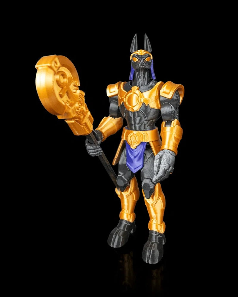 Front view of a jackal-headed armored figurine holding a staff with a round gold head.