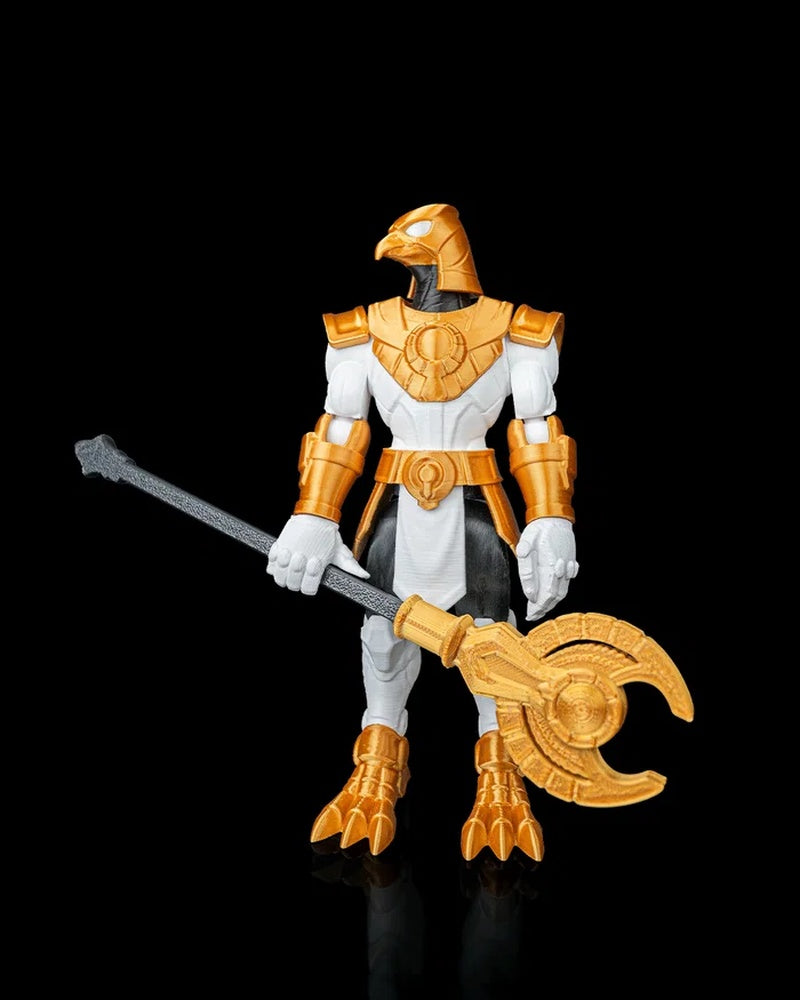 Falcon-headed armored figurine in white, black, and gold colors holding a long black-and-gold staff on a black background.