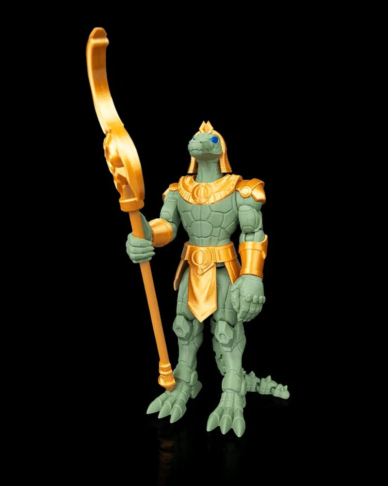 Angled front view of a green crocodile-headed armored figurine holding a tall gold-colored curved polearm on a black background.