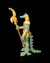 Side view of a green crocodile-headed armored figurine with a tail and a gold-colored curved polearm on a black background.