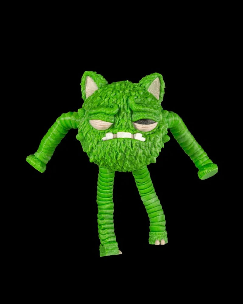 Green furry creature figurine with pointed ears, droopy eyes, white teeth, and long ribbed limbs on a black background