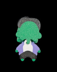 Back view of a green monster figurine with dark hair and a purple jacket on a black background
