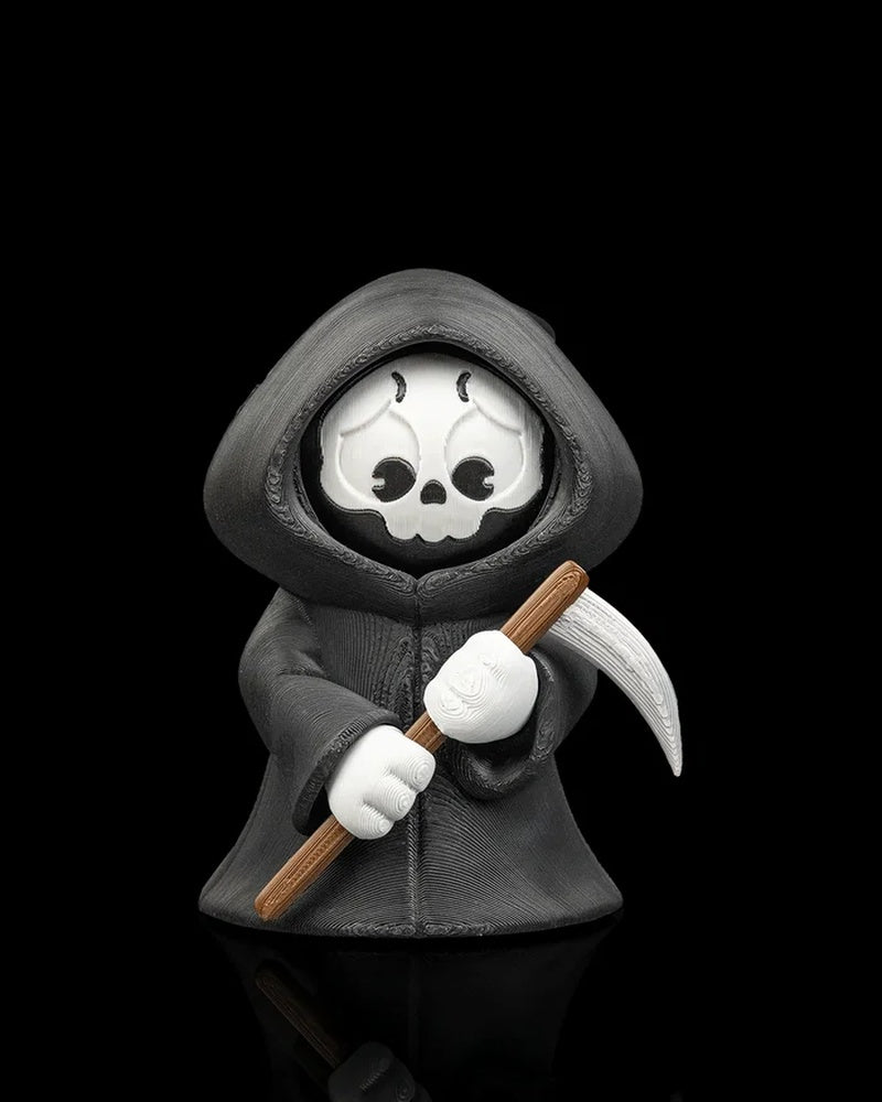 Hooded reaper figure holding a scythe with a sad skull face on a black background