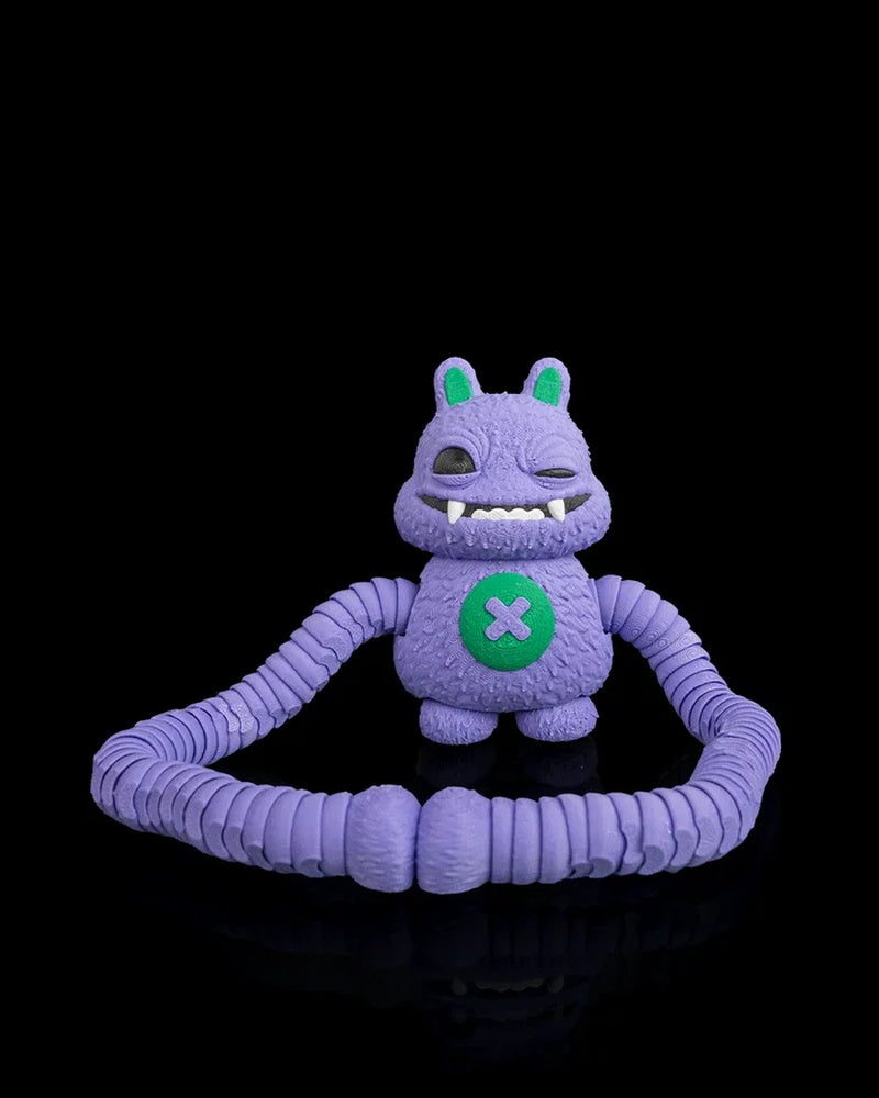 Purple monster figurine seated with long ribbed arms looped in front on a black background