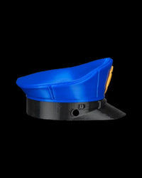 Side view of a blue cap with a black band and small round hole on a black background