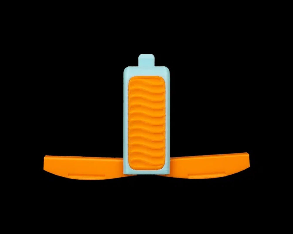 Orange and light blue whistle-shaped figurine with side panels extended on a black background