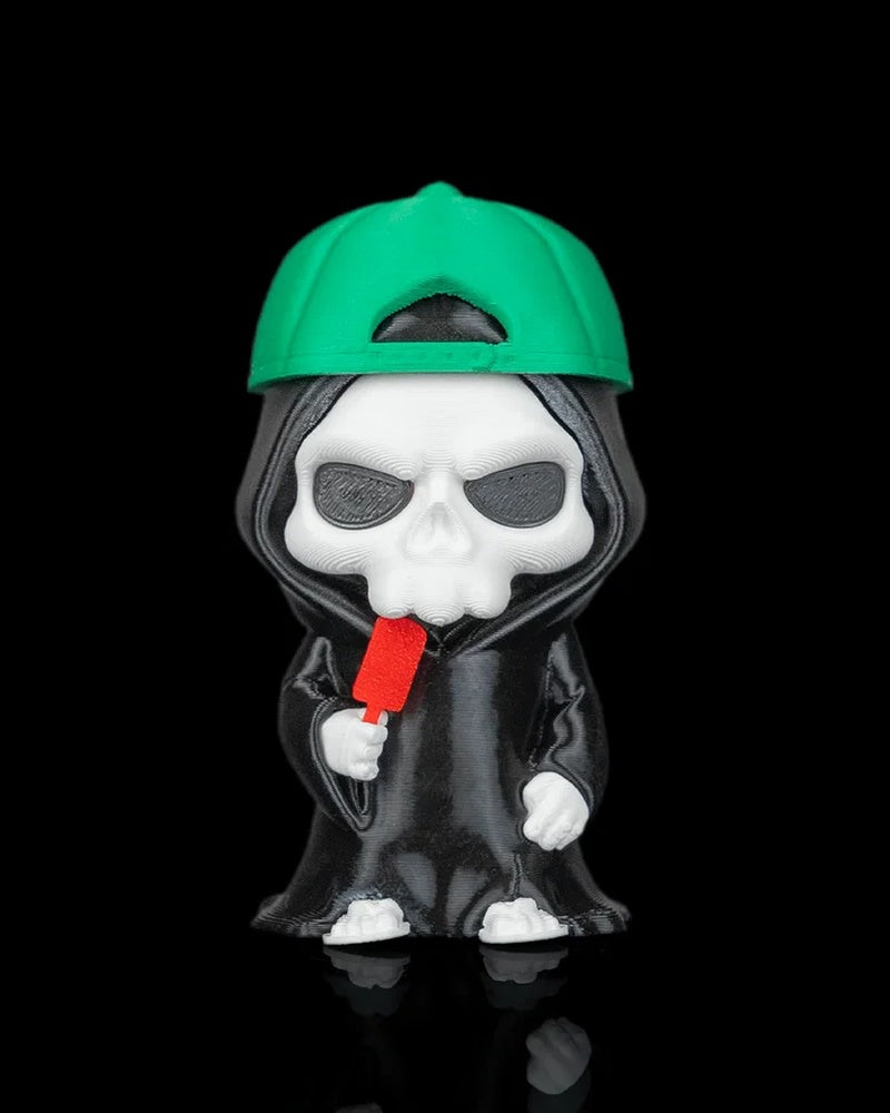 Hooded skull figurine wearing a green cap and holding a red pop on a black background