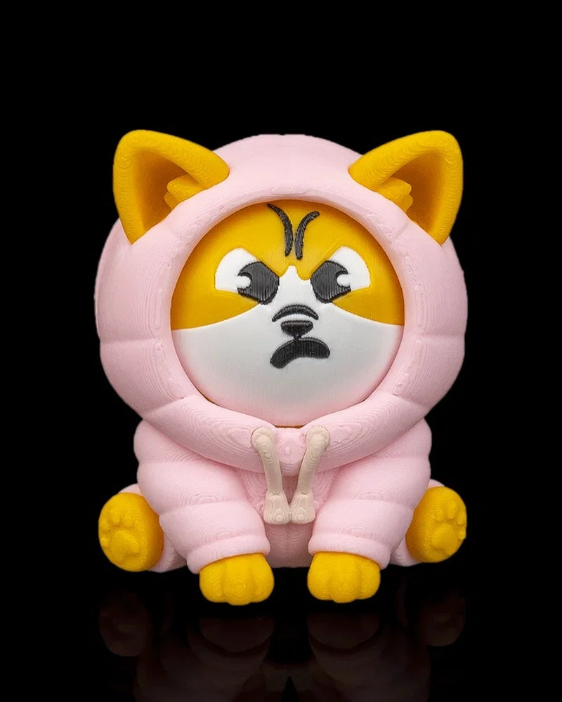 Front view of a yellow and white dog figurine in a pink hood with an angry face on a black background.
