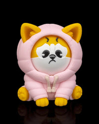 Front view of a yellow and white dog figurine in a pink hood with a sad face on a black background.