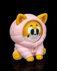 Angled front view of a yellow and white dog figurine in a pink hood with a smiling face on a black background.