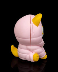Side view of a yellow dog figurine wearing a pink hood with a yellow tail on a black background.