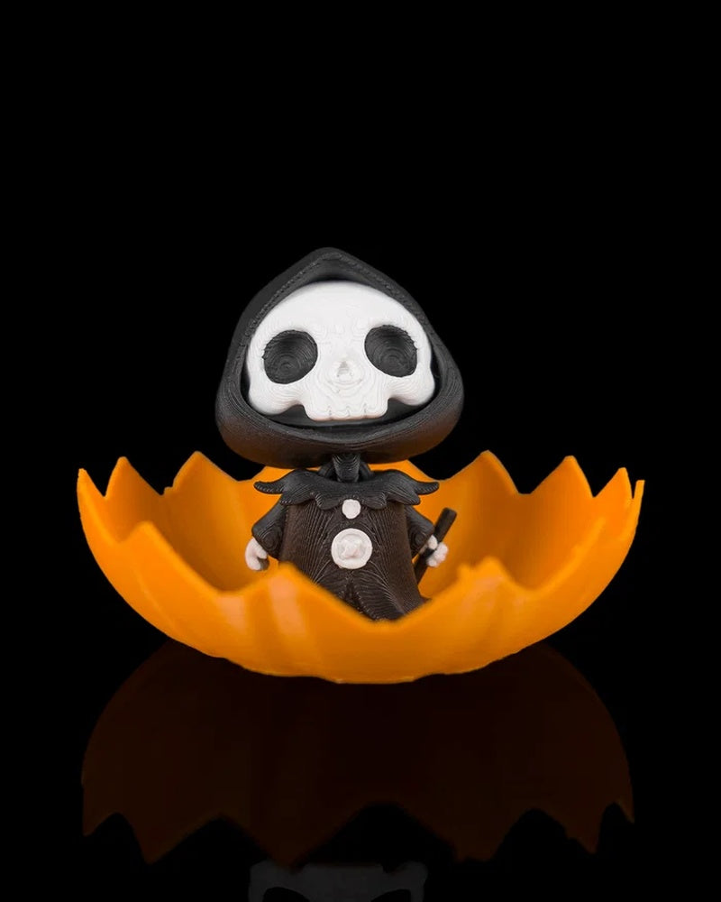 Hooded skull character sitting inside an open orange pumpkin shell