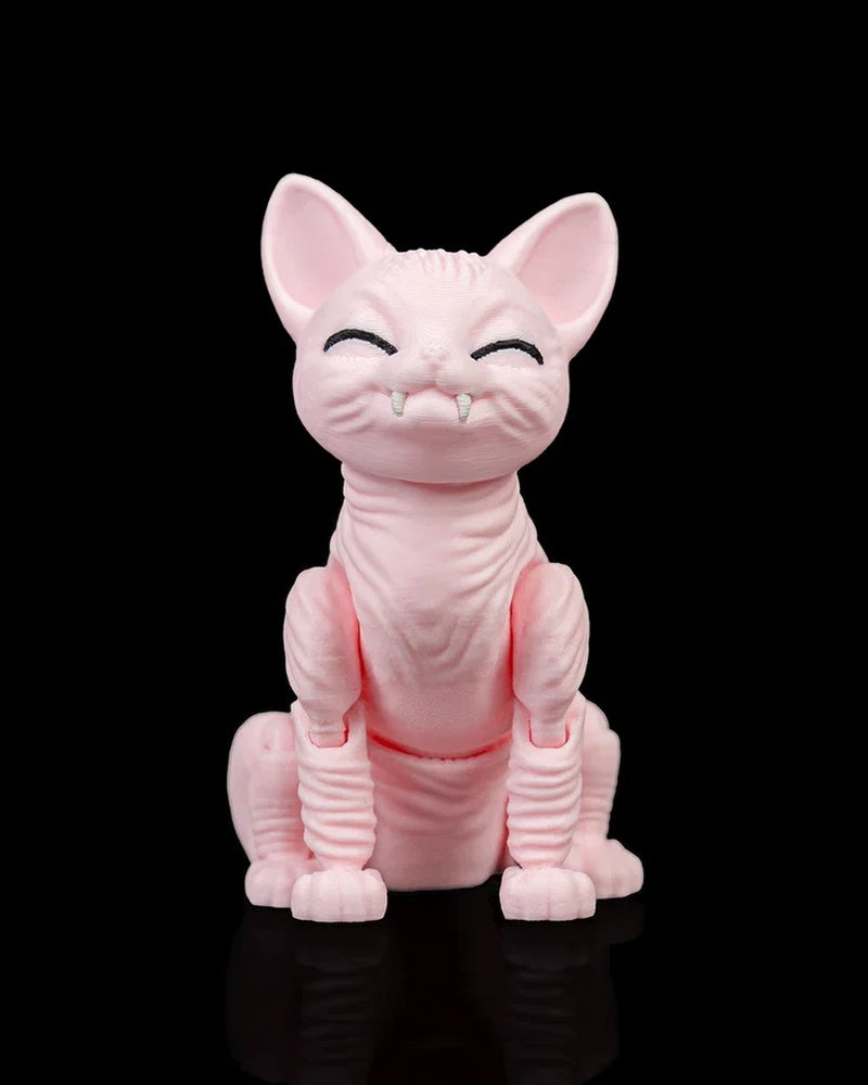 Front view of a pink cat figurine with large ears, closed black eyes, small white fangs, and a seated pose on a black surface.