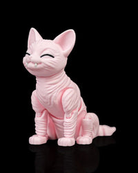 Angled front view of a pink cat figurine with large ears, closed black eyes, small white fangs, and a seated pose.