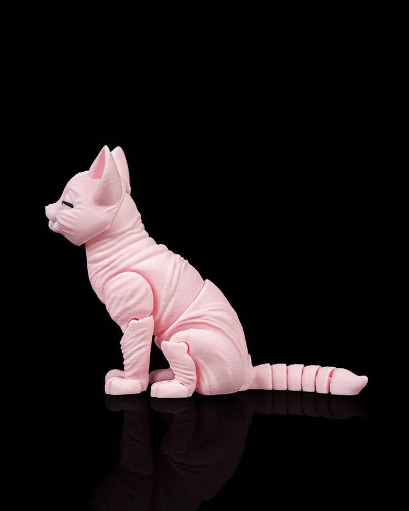 Left side view of a pink cat figurine with large ears, wrinkled body details, and a long segmented tail on a black surface.