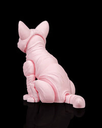 Rear angled view of a pink cat figurine with large ears, wrinkled back details, and a tail extending behind it.