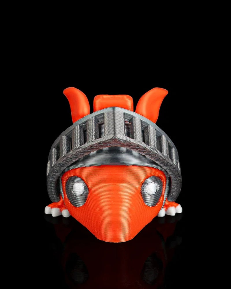 Front close-up of an orange dragon figurine with a raised gray visor and white eyes