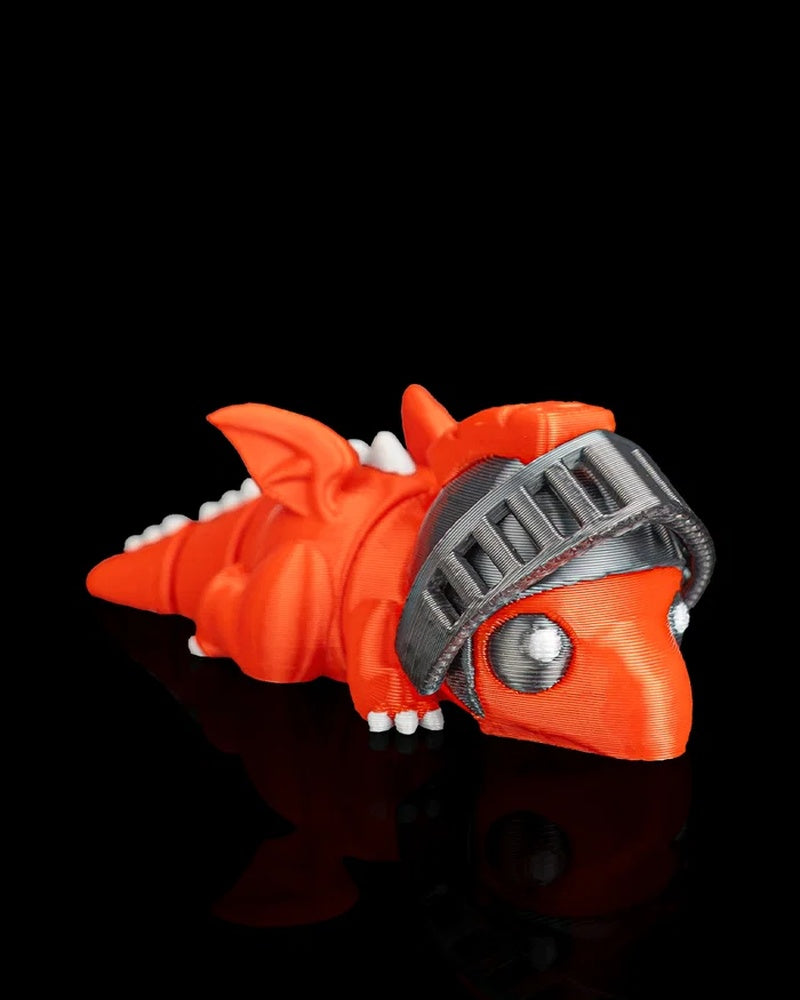 Angled side view of an orange dragon figurine with wings, white back spikes, and a gray helmet