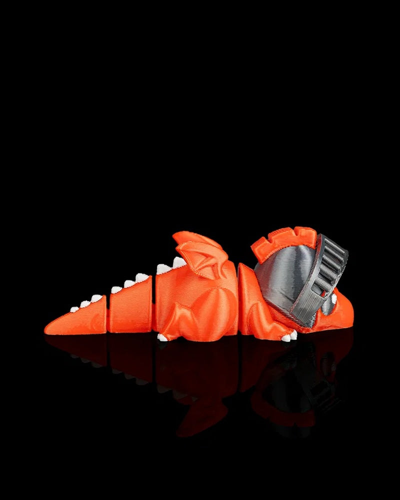 Side view of an orange dragon figurine with segmented tail, wings, white spikes, and gray helmet