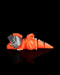 Side view of an orange dragon figurine with wings, segmented tail, white spikes, and gray visor