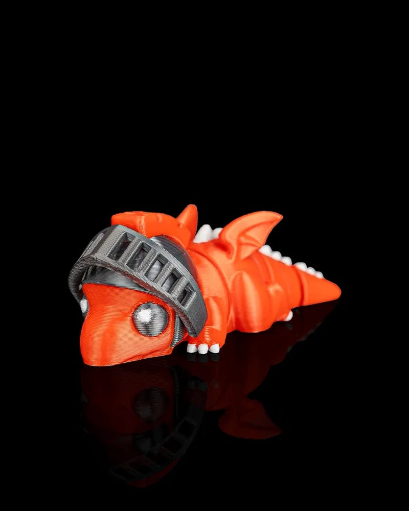 Angled front view of an orange dragon figurine with gray visor, white eyes, wings, and tail