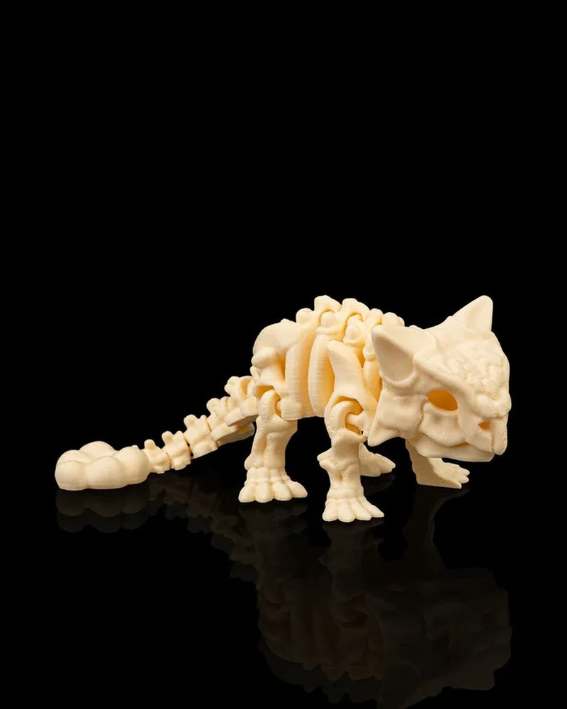 Cream-colored ankylosaurus skeleton-style figurine facing right on a black reflective surface