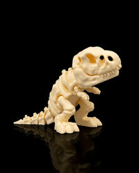 Cream T-Rex skeleton figurine standing on a black reflective surface