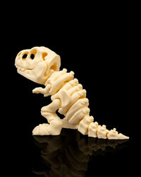 Rear side view of a cream T-Rex skeleton figurine with tail and rib sections visible