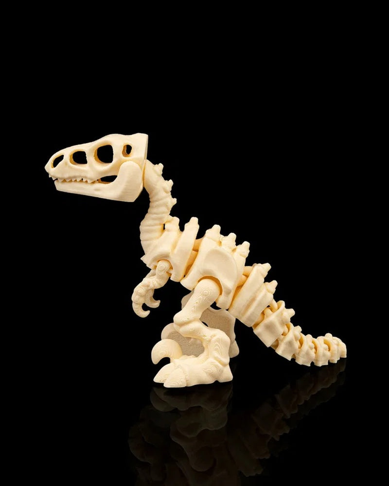 Side view of a cream-colored velociraptor skeleton figurine on a black reflective surface