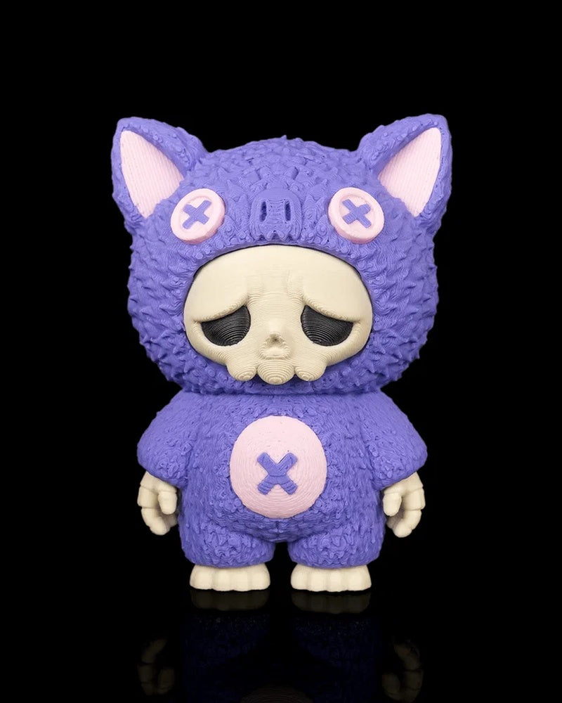 Purple bat-themed skull figurine with pink button accents on a black background