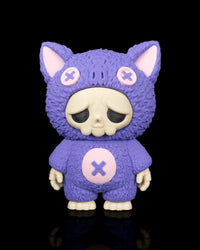 Purple bat-themed skull figurine with pink button accents on a black background