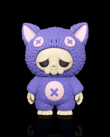 Purple bat-themed skull figurine with pink button accents on a black background