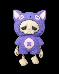 Purple bat-themed skull figurine with dangling arms and legs on a black background