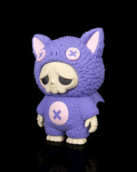 Angled view of a purple bat-themed skull figurine with pink accents and small wings